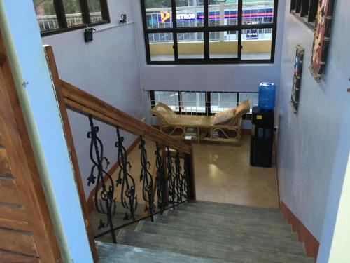 a stairway with a chair and a window at Mayon Lodging House in Legazpi