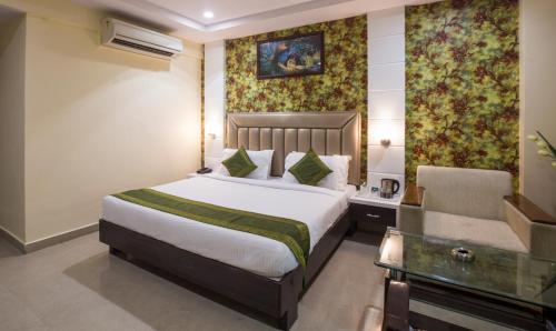 a hotel room with a bed and a chair at Hotel City Center Jodhpur in Jodhpur