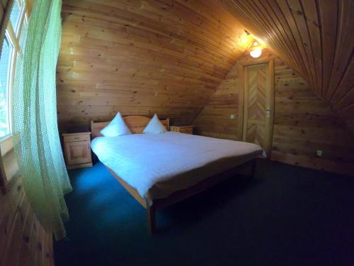 a bedroom with a bed in a wooden cabin at Bukdangas in Usma