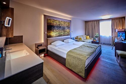 a hotel room with a bed and a bath tub at Posthotel Walhalla Regensburg Ost in Donaustauf