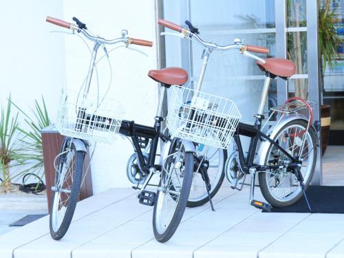 two bikes parked next to each other in front of a building at Hotel AreaOne Fukuyama in Fukuyama