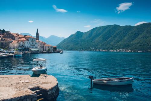 two boats are docked in a body of water at Heritage Grand Perast By Rixos in Perast