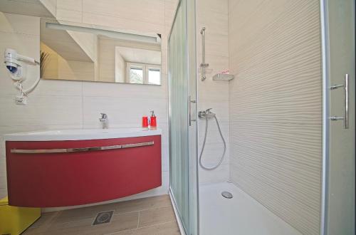 a bathroom with a red sink and a shower at Villa Radić in Ston