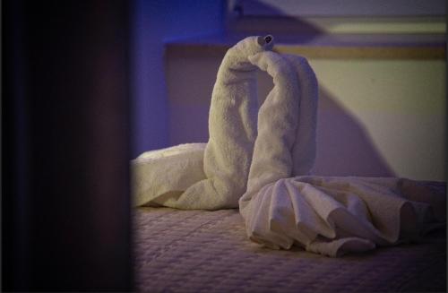 a stuffed animal is sitting on a bed at Villa Radić in Ston