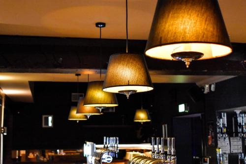 a group of lights hanging above a bar at Dalziel Park Hotel in Motherwell