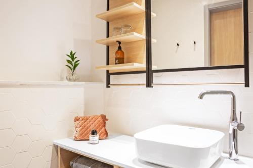 a white bathroom with a sink and a mirror at Sunprime Protaras Beach - Adults Only in Protaras