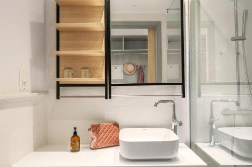 a white bathroom with a sink and a mirror at Sunprime Protaras Beach - Adults Only in Protaras