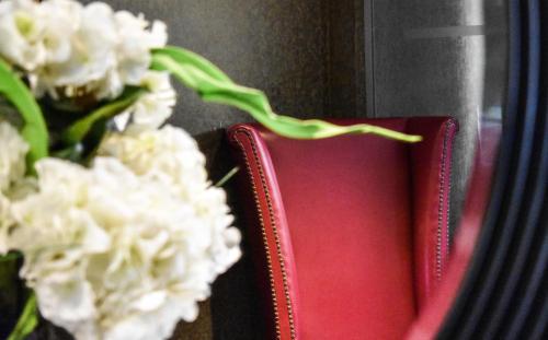 a red book sitting next to some white flowers at Dalziel Park Hotel in Motherwell