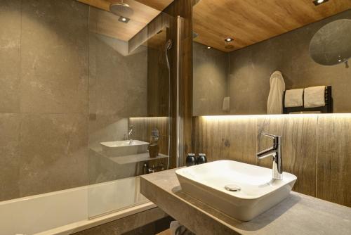 a bathroom with a sink and a shower at Alpina Eclectic Hotel in Chamonix-Mont-Blanc