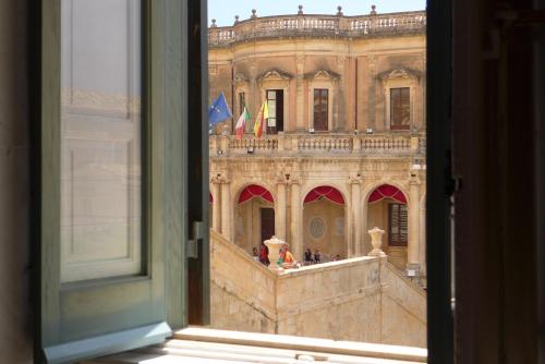 a view of a large building from a window at Landolina Palace Hotel in Noto