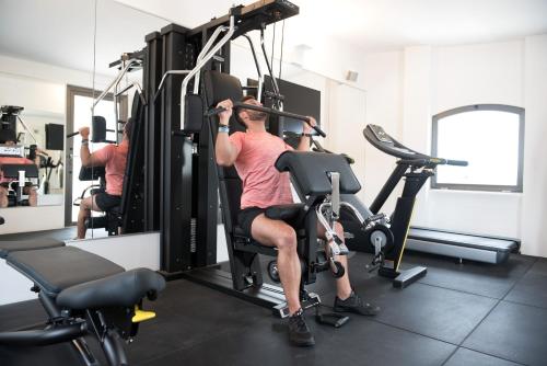 two men in the gym on exercise bikes at Gasometer Urban Suites in Rome