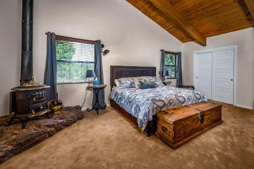 a bedroom with a bed and a wood stove at The Treehouse in Munds Park