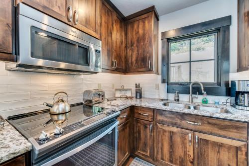 a kitchen with wooden cabinets and a stainless steel appliances at Tamarack Townhouse in Donnelly