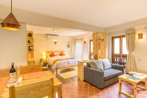 a bedroom with a bed and a living room at Hotel Timila in Pātan