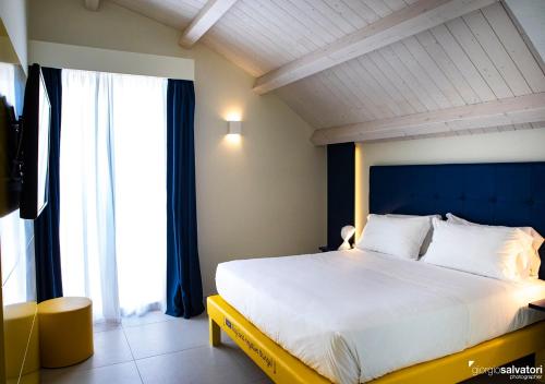 a bedroom with a large bed with a large window at Hotel Trevi in Bellaria-Igea Marina