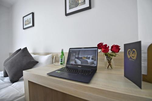 a laptop computer sitting on a desk in a room at Lubhotel in Lublin
