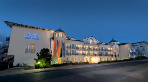 a large building with a sign on the side of it at Dorint Strandhotel Binz/Rügen in Binz