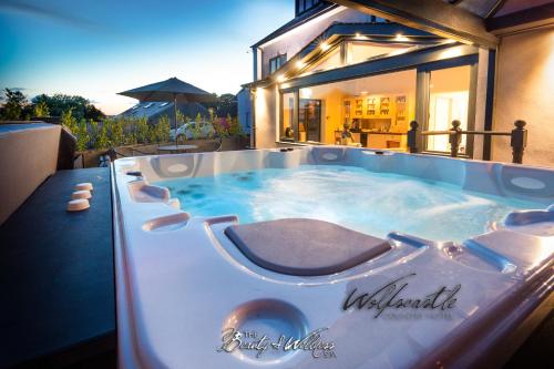 a hot tub in the backyard of a house at Wolfscastle Country Hotel in Haverfordwest
