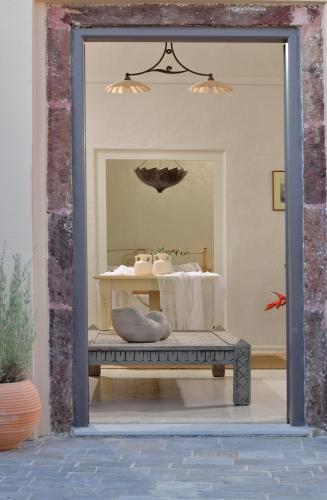 a store window with a bench in front of a mirror at ALIA MANSION by K&K in Megalokhori