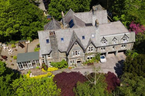 an aerial view of a large house in the trees at The Old Vicarage in Ambleside