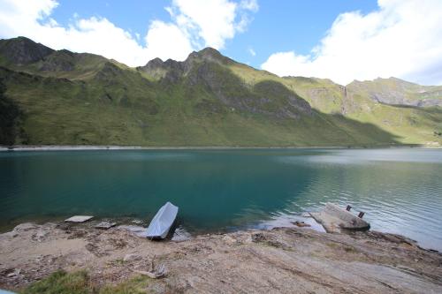 a body of water with a mountain in the background at Chalet Cuore delle Alpi in Airolo