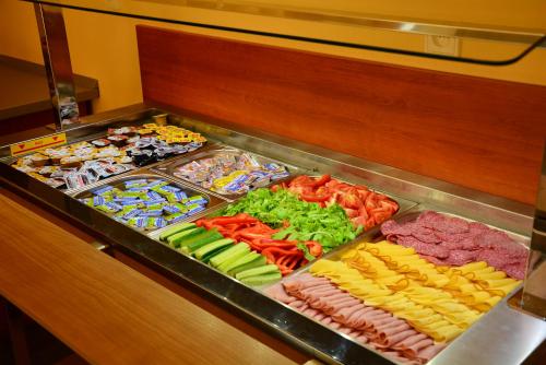 a buffet line with different types of food at Hotel&Wellness Knížecí rybník in Tábor