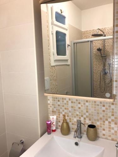 a bathroom with a sink and a mirror at Suite & Relax in Conversano