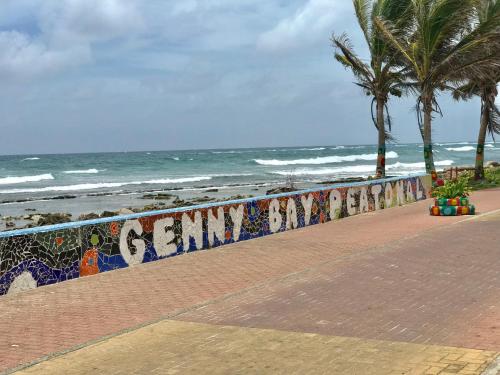 a wall with graffiti on it next to the beach at Sunshine Boutique Hotel in San Andrés