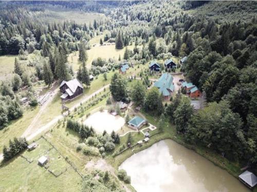 an aerial view of a house next to a river at Vilni Vitry in Osmoloda