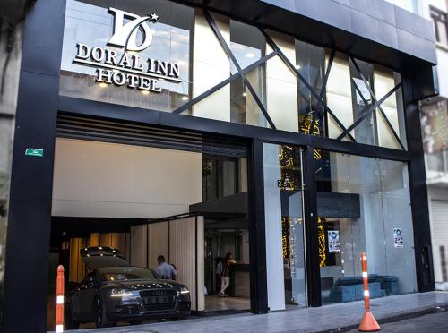 a car is parked outside of a hotel at Hotel Doral Inn in Ibagué