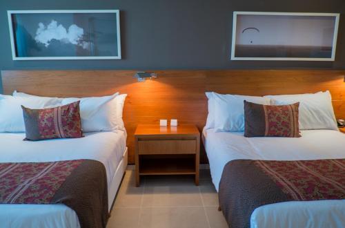 Katil atau katil-katil dalam bilik di Orfeo Suites Hotel Sierras Chicas