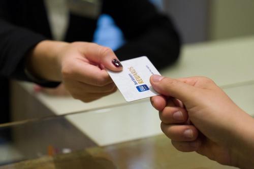a person holding a credit card in their hands at Best Western Madison Hotel in Milan
