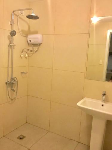a bathroom with a shower and a sink at Cedar Peak Condominium in Baguio