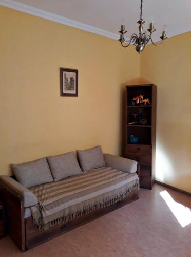 a couch in the corner of a living room at Apartment in the historical city center in Chernivtsi