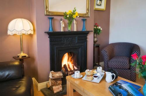 a living room with a fireplace and a coffee table at Island View Roundstoneselfcatering in Roundstone