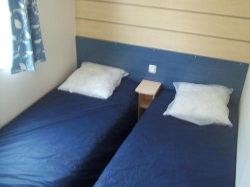 Een bed of bedden in een kamer bij Camping Paradis Les Galets de la Molliere