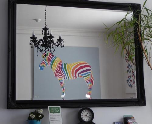 a painting of a zebra in a mirror at Bamboo Guesthouse in Bournemouth