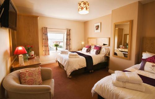 a hotel room with two beds and a television at Island View B&B in Roundstone