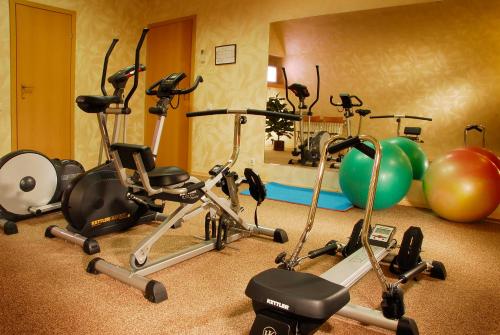a gym with several exercise bikes and exercise balls at Premier Hotel Palazzo in Poltava