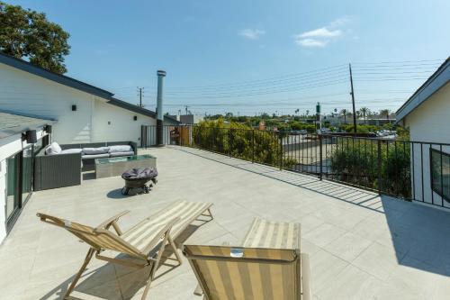 a patio with two chairs and a bench on a balcony at Venice Beach Gem in Los Angeles