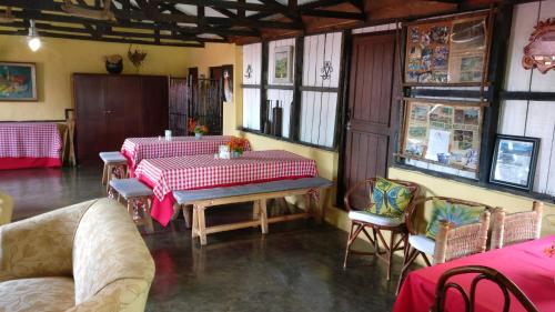a dining room with a table and chairs in a room at Villa Pajon Eco Lodge in Constanza