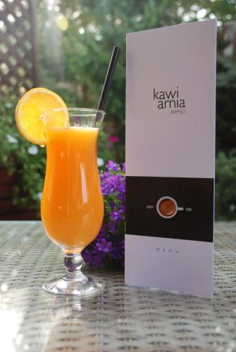 a glass of orange juice on a table next to a box at Mevo Apartament - Apartamenty 4 -6 osobowe in Polańczyk