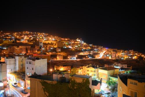 a city at night with lots of lights and lots of buildings at Anbat Midtown Hotel in Wadi Musa