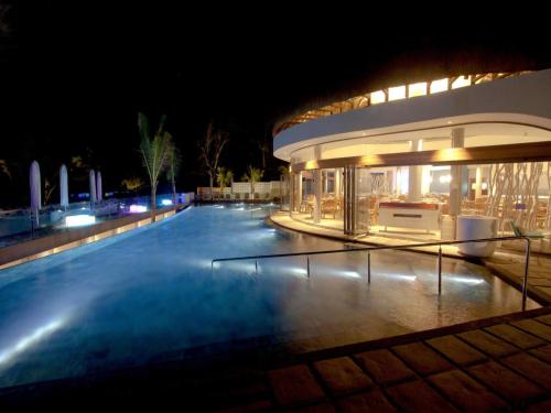 a large building with a swimming pool at night at Radisson Blu Poste Lafayette Resort & Spa (Adults Only) in Poste Lafayette