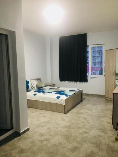a bedroom with a bed and a window at Batumi Hotel in Batumi