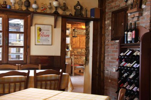 a dining room with a table and some wine bottles at To Xani in Palaios Panteleimon