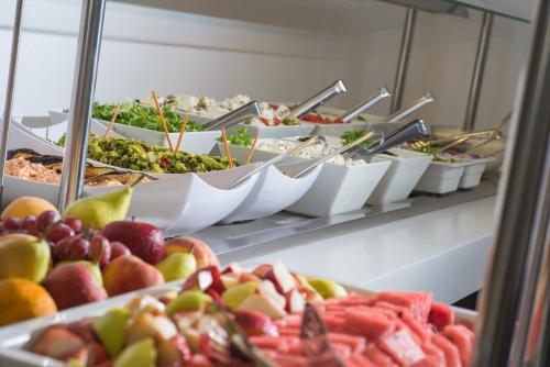 a buffet filled with lots of different types of food at Belvedere Village in Agia Pelagia