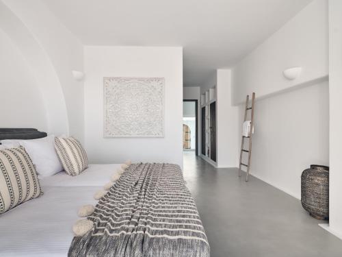 a white room with a bed and a ladder at The Asteri Collection -Villa Antilia in Agios Nikolaos