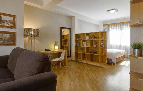 a living room with a couch and a bed at Acropolis View Penthouse in Athens