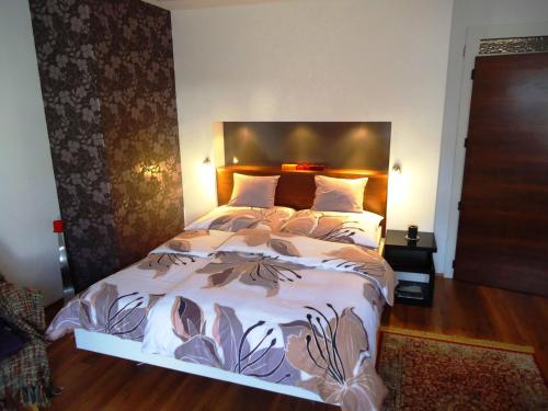 a bedroom with a large bed in a room at Buda Panzió in Győr